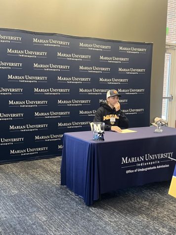 A student signing to commit to MU