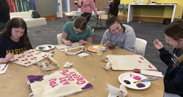 Students painting on their souvenir tote bags at Pi day.
