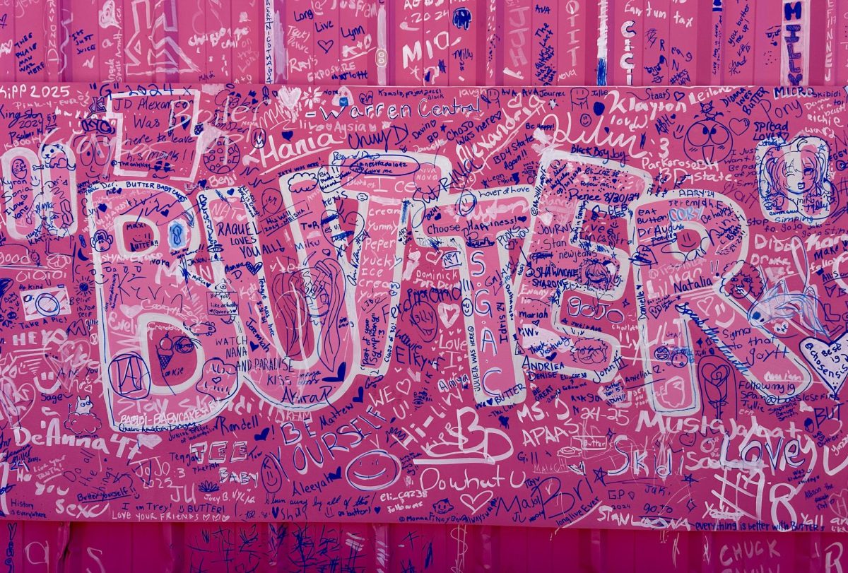 “BUTTER” logo printed and decorated with visitor’s artwork on the warehouse where the artwork is located.  
