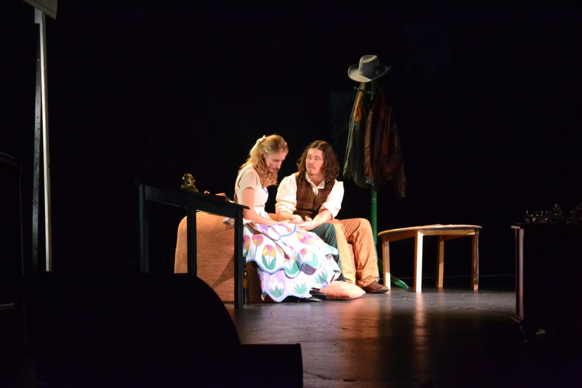 Julianna Britt as Laura (left) and J.P. Schuette as Jim (right), performing in The Glass Menagerie.
